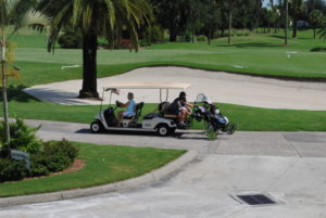 Volunteers bring Junior Golfers to their next hole. 